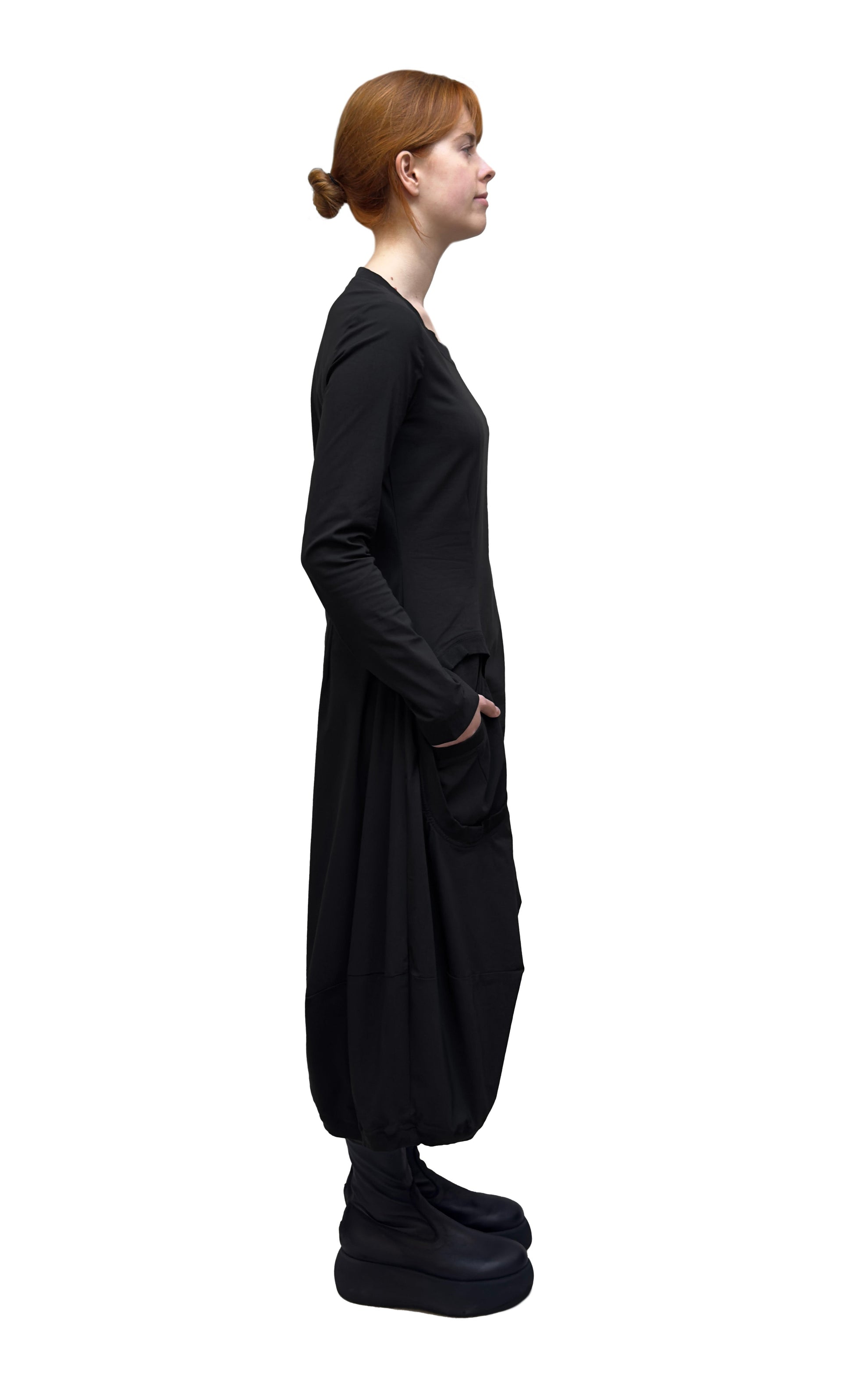 Women's long sleeve, round neck A-line dress with circular in-set front pockets. Made in a technical fabric from Black Label. In colour Black. Side view. 
