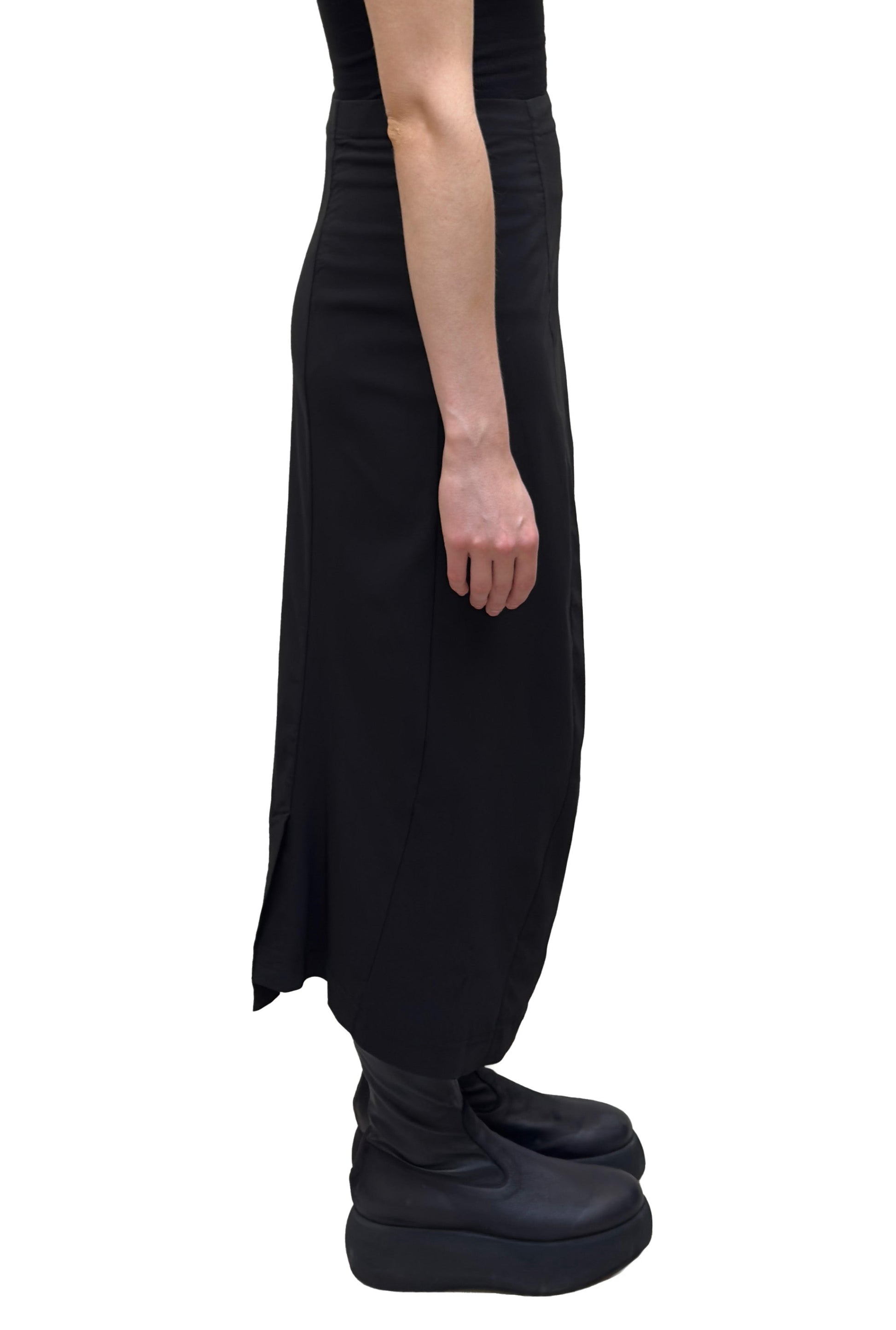 Women's ankle length fitted pencil skirt with a flat elastic waistband. Made in a technical fabric from Black Label. In colour black. Side view.
