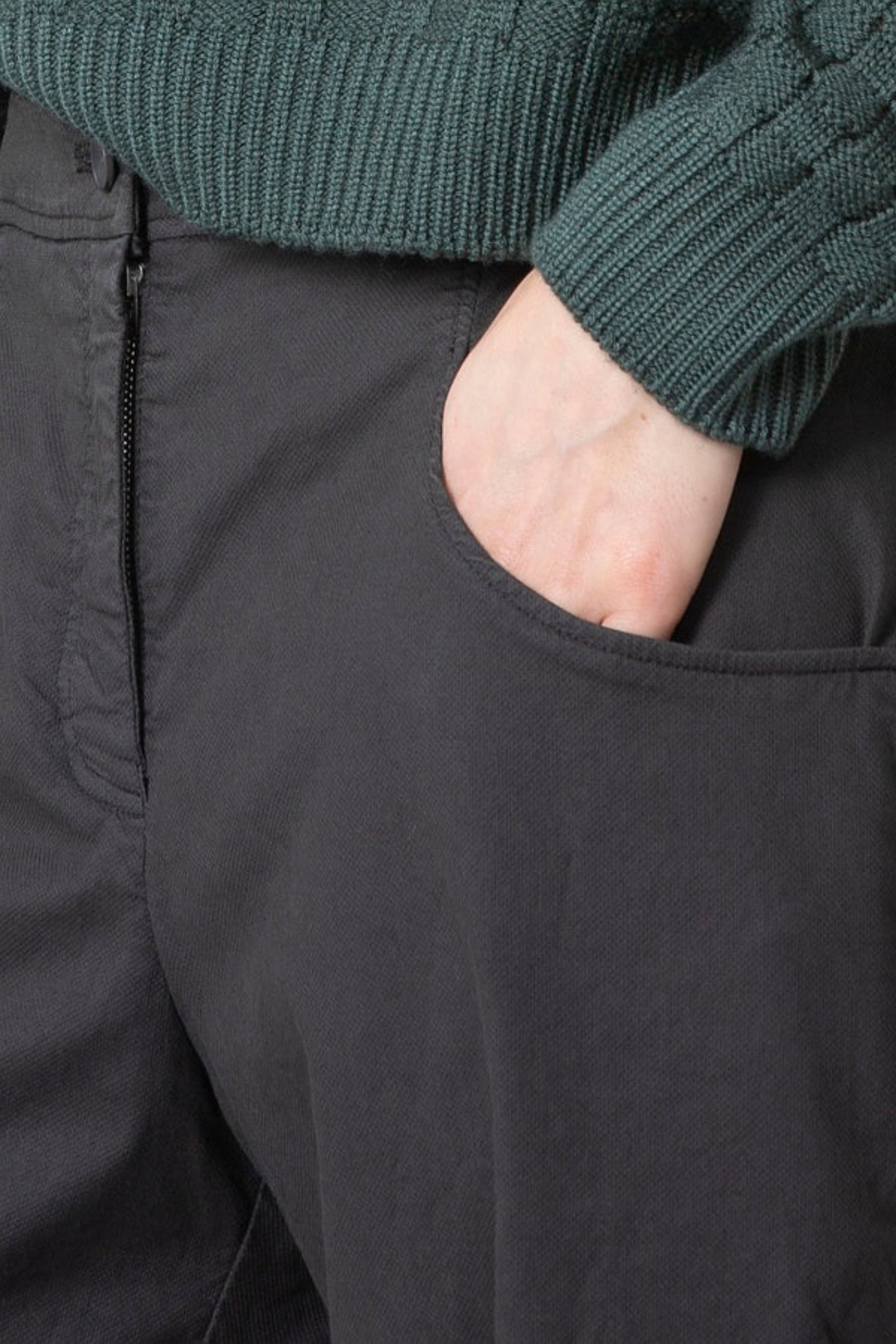 Women's long barrel leg pant with flat front button closure, curved front slash pockets and back patch pockets. Made in a textured cotton fabric from Oska. Detail view.