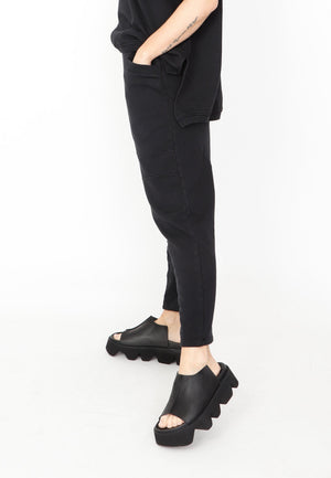 Women's relaxed drop rise pant featuring side pockets and an elastic waistband. Made in a French Terry fabric. In colour black by Sort Aarhus. side view.