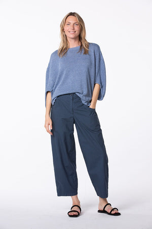 Women's ankle length, tapered  cropped pant with slash pockets, front button closure and elasticized waist at the back. Made in a cotton poplin by Oska. Full view.
