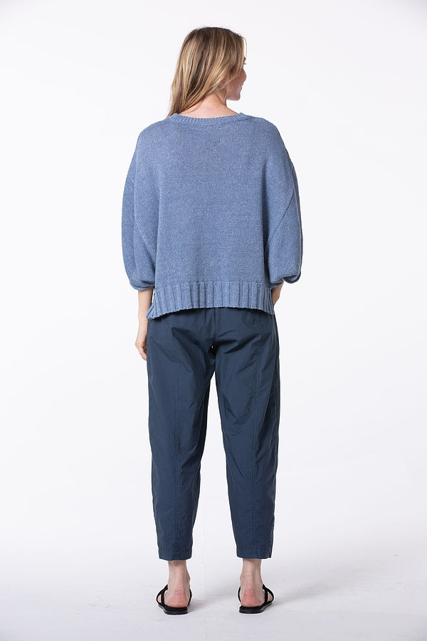 Women's ankle length, tapered  cropped pant with slash pockets, front button closure and elasticized waist at the back. Made in a cotton poplin by Oska. Back view.