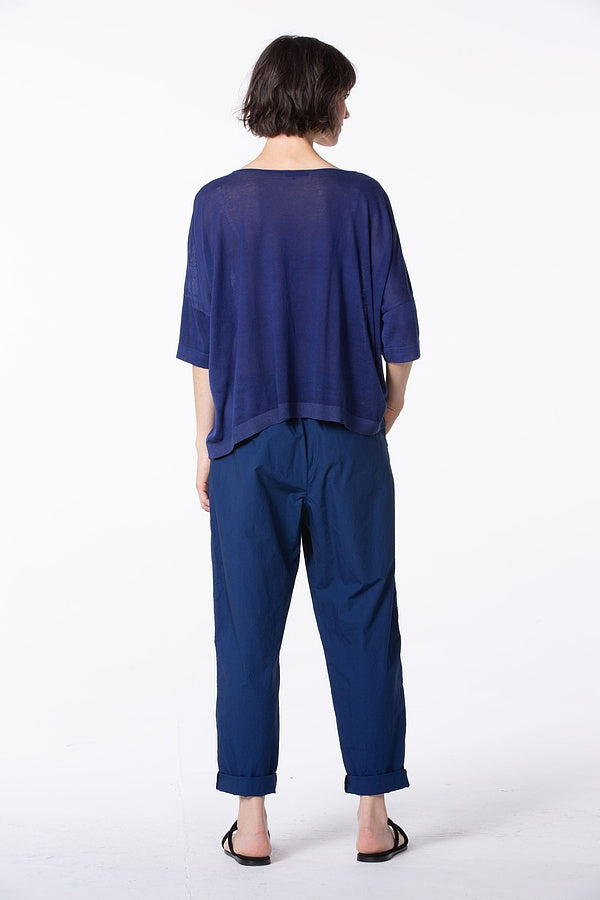 Women's long, cuffed tapered pant, with front button closure, squared pockets, and back elasticized waistband by Oska. Back view.