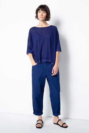 Women's long, cuffed tapered pant, with front button closure, squared pockets, and back elasticized waistband by Oska. Full front view.